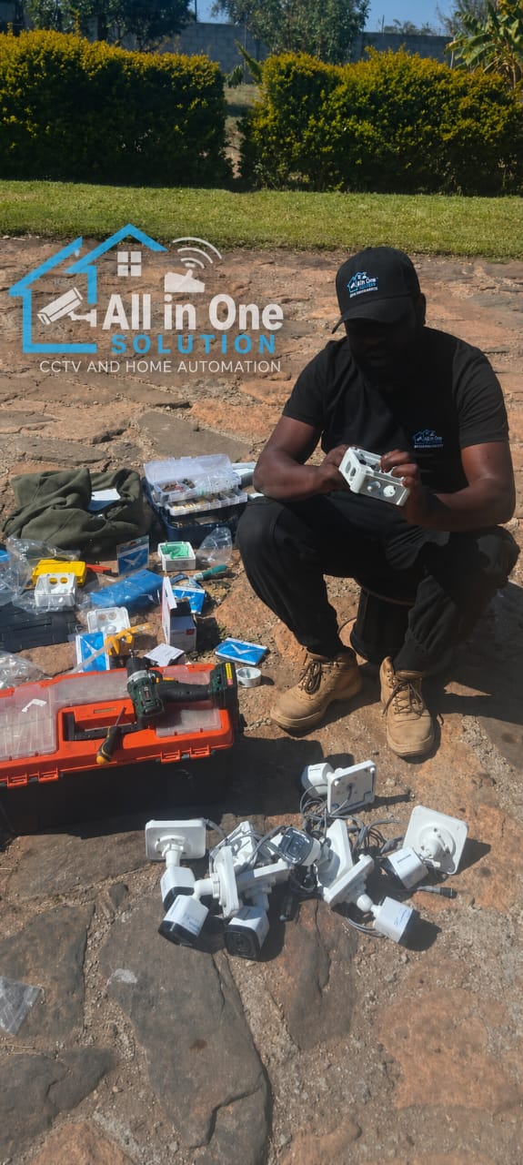 Technician prepping camera kit on site — Harare
